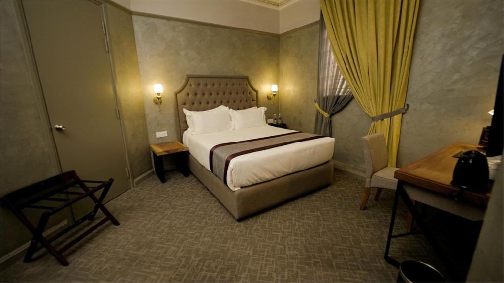 Postel nebo postele na pokoji v ubytování 1969 Business Suites @ Ipoh Garden