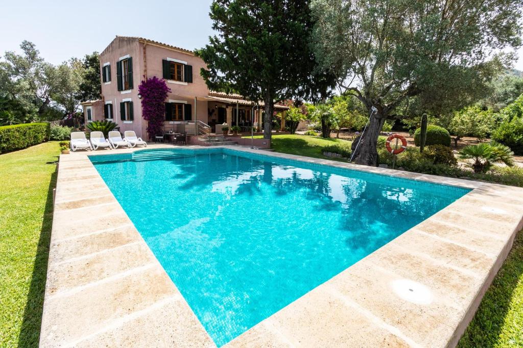 een zwembad voor een huis bij Villa Alzina in Alcudia