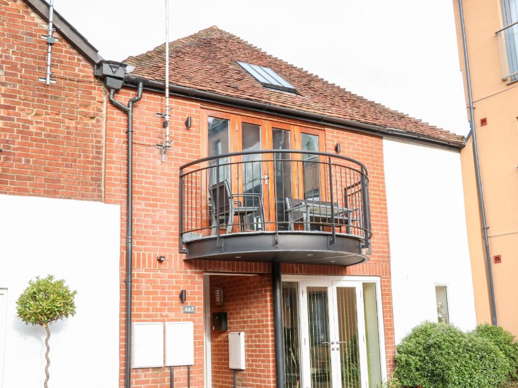 a house with a balcony on the front of it at 4 Holt Court in Salisbury