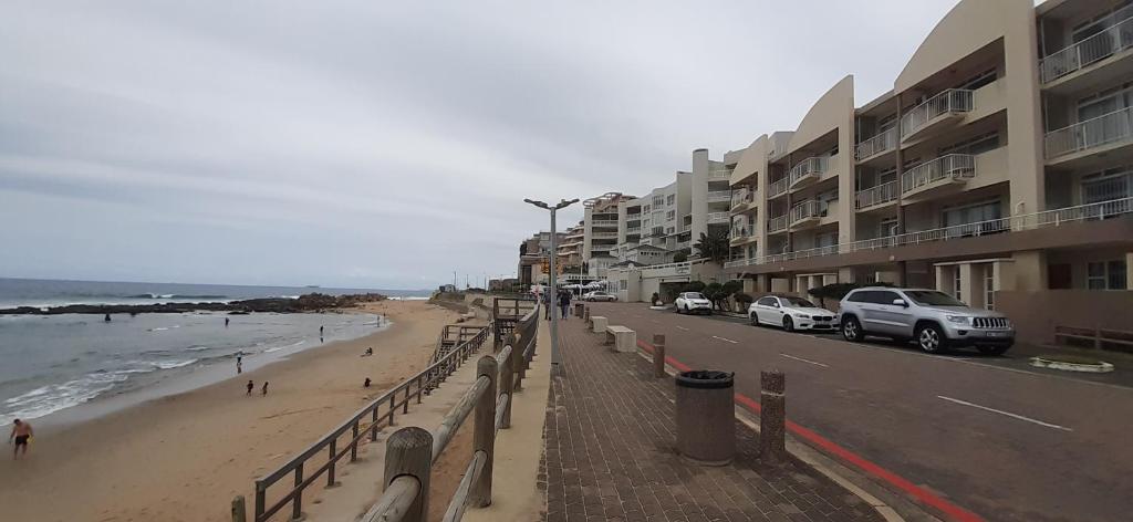 a view of a beach with cars parked on the street at Ann's Place in Umdloti