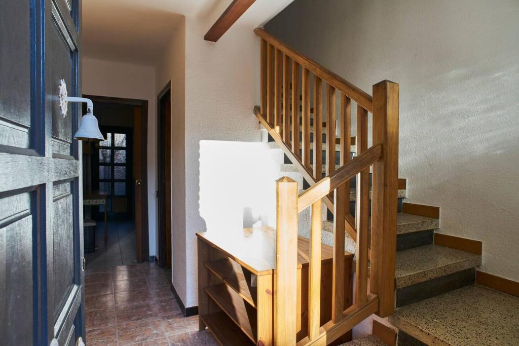 a hallway with a wooden staircase in a house at Holidays Domus Iano in Esparraguera