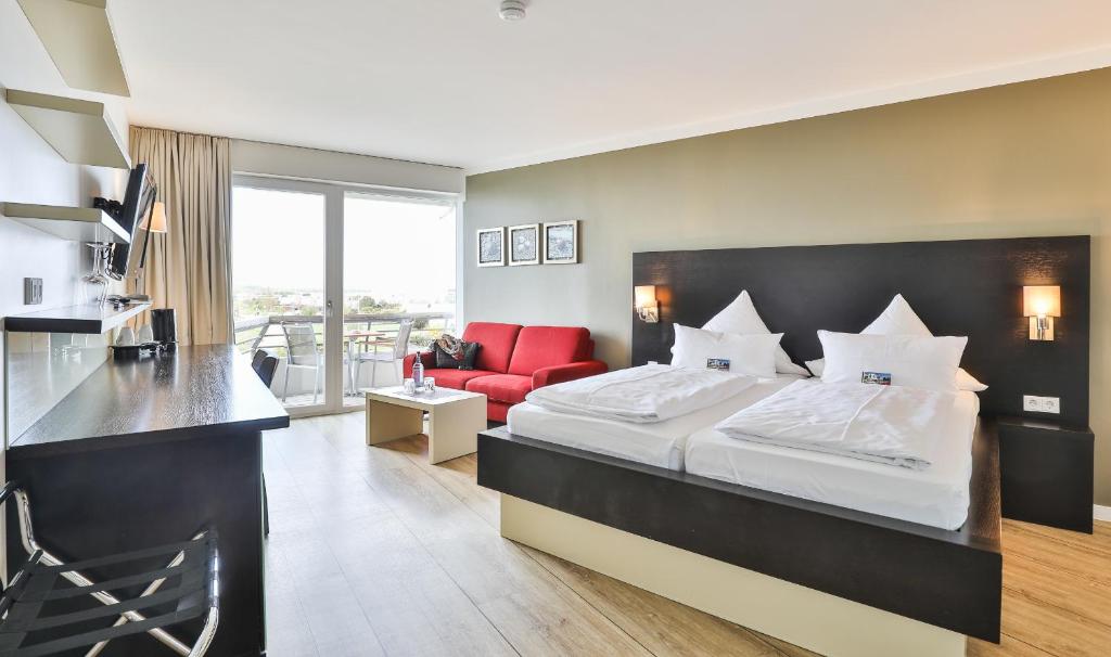 Postel nebo postele na pokoji v ubytování Strandhotel Bene