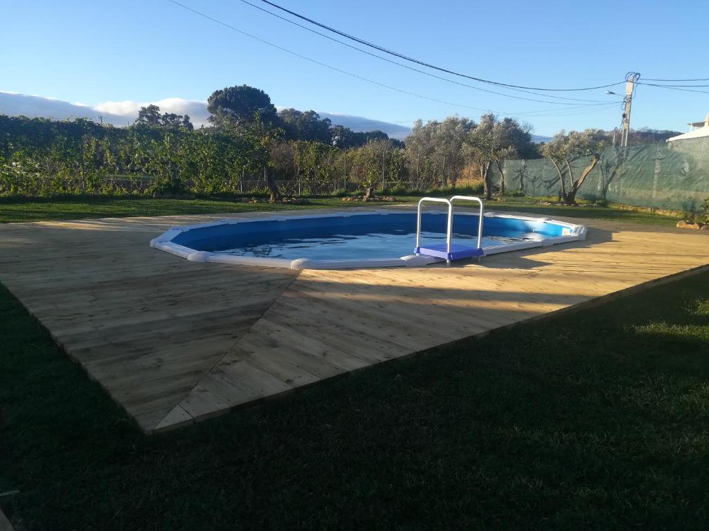 a small swimming pool in a yard with a playground at One bedroom appartement with shared pool enclosed garden and wifi at Monchique in Monchique