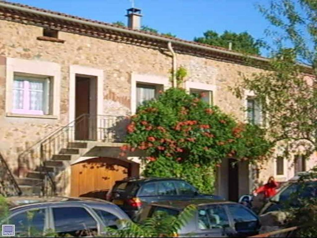 a group of cars parked in front of a building at Maison confortable à Lunas avec vue montagne + jardin in Lunas