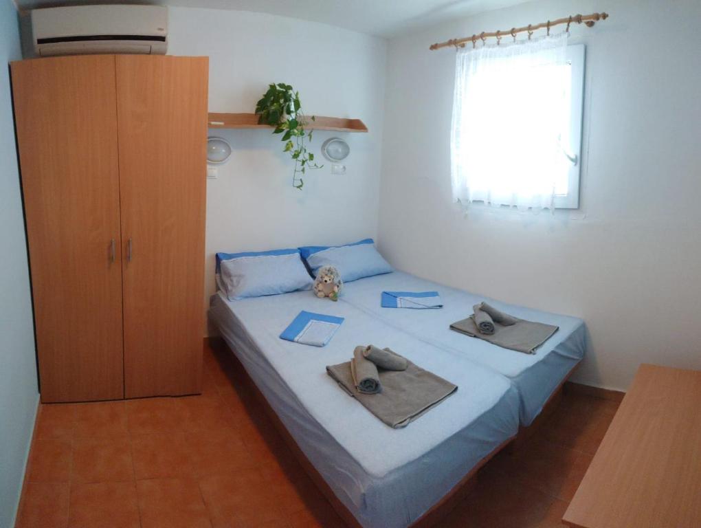 1 dormitorio con 1 cama con toallas en Apartments Villaggio Riccio, en Mattinata