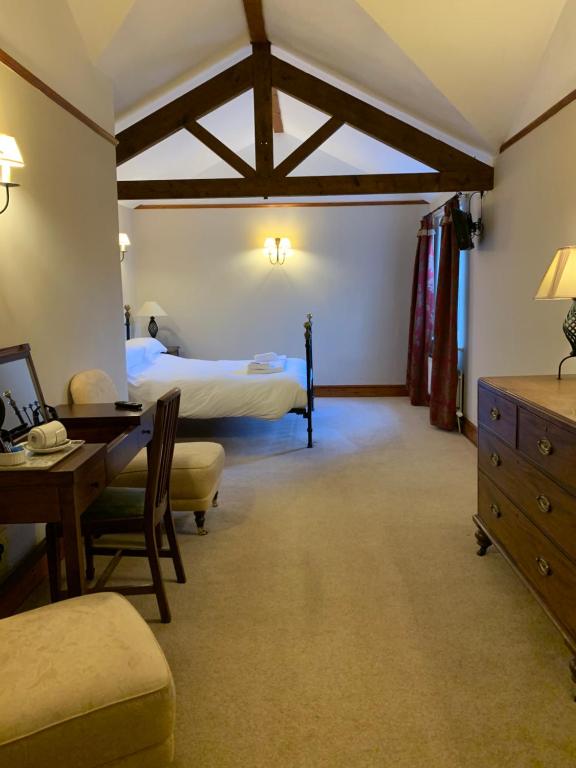 a bedroom with a bed and a desk at The Charles Bathurst Inn in Richmond