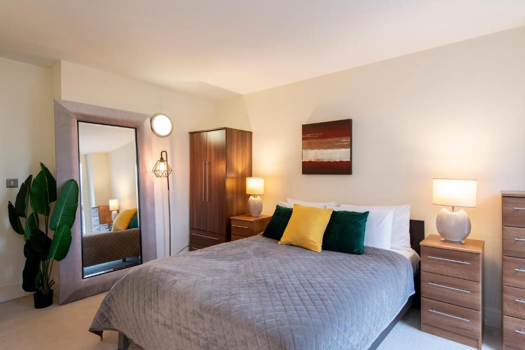 a bedroom with a bed and a large mirror at One Bed Apartment in Waterloo near Southwark in London