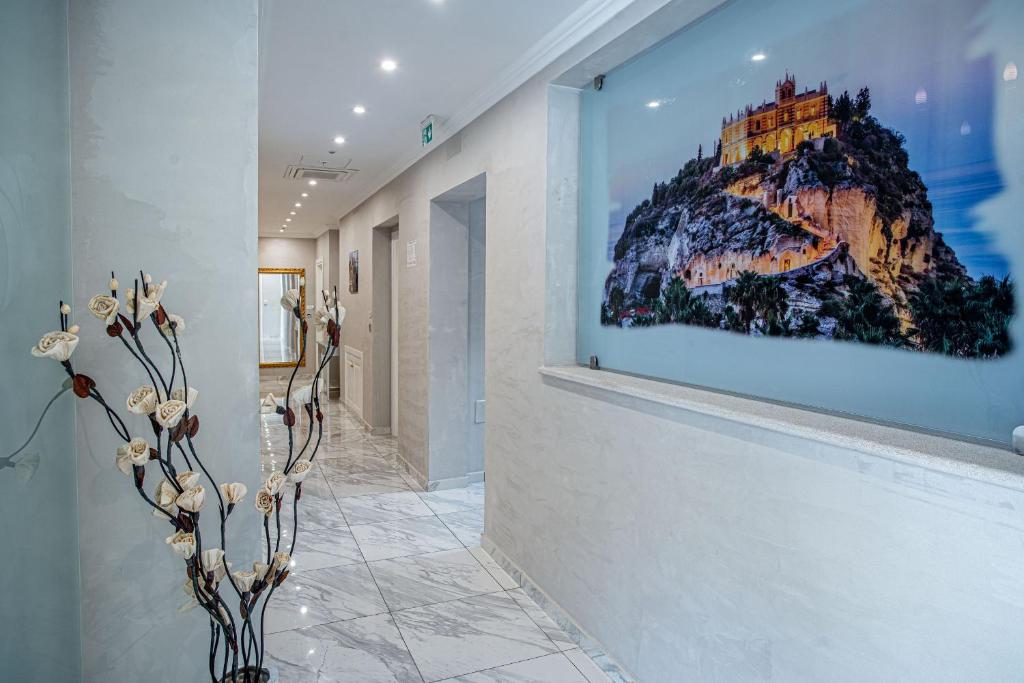 a painting of a mountain on the wall in a hallway at Hotel Colomba D'Oro in Tropea