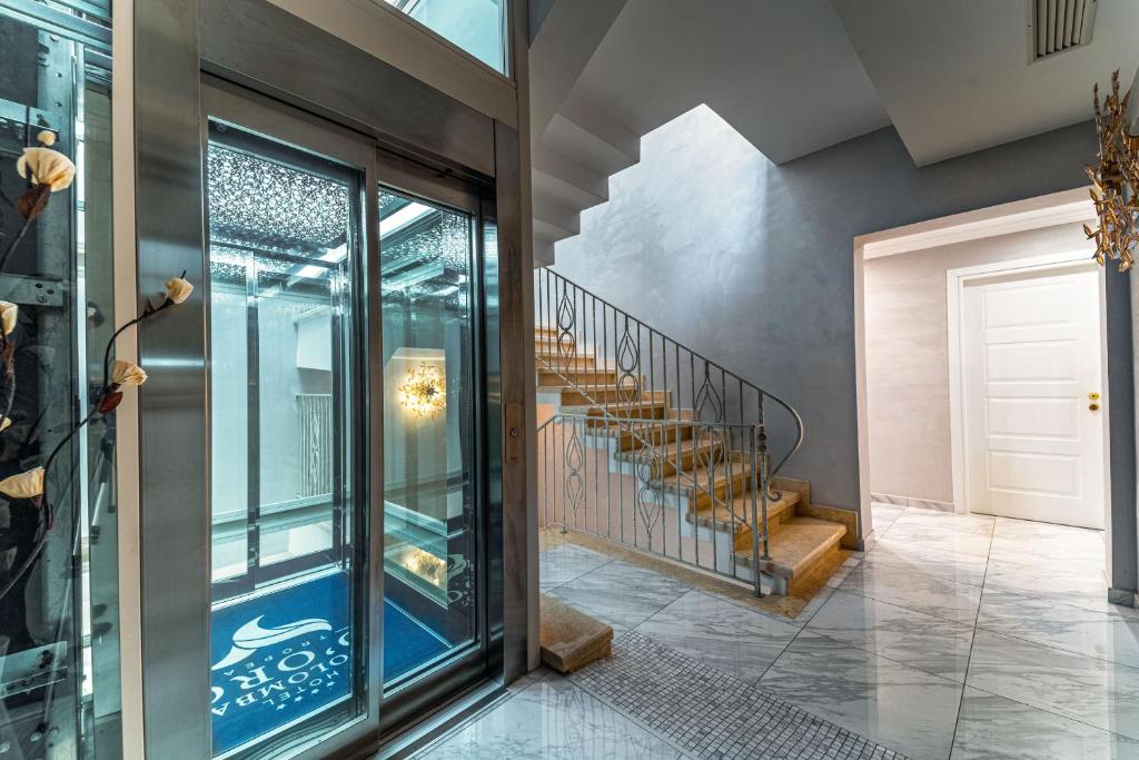 a hallway with a glass door and stairs at Hotel Colomba D'Oro in Tropea