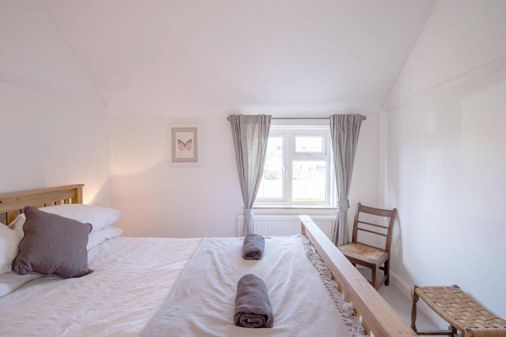 a bedroom with a large bed with slippers on it at Avocet House in Wells next the Sea