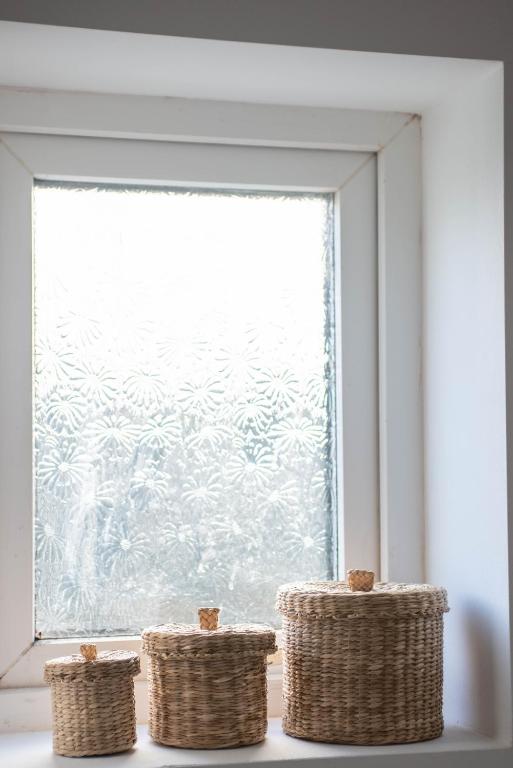 a window with three wicker baskets in front of it at Avocet House in Wells next the Sea
