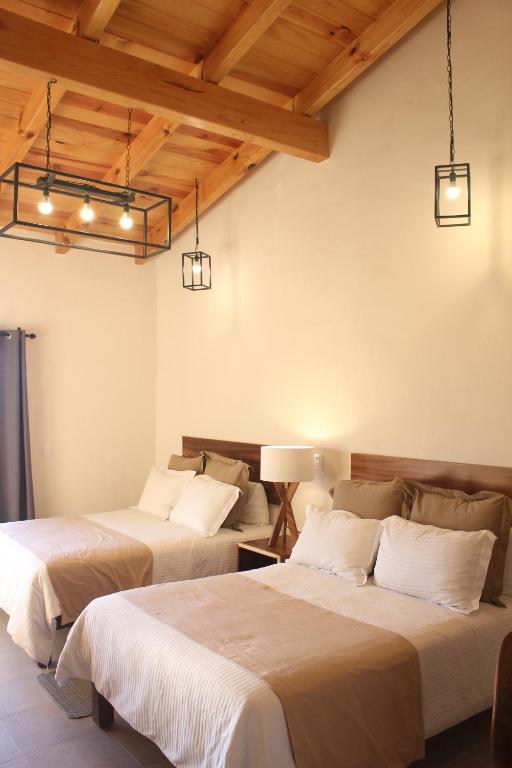 Postel nebo postele na pokoji v ubytování Hotel Quinta del Bosque