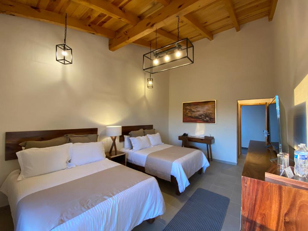 Postel nebo postele na pokoji v ubytování Hotel Quinta del Bosque