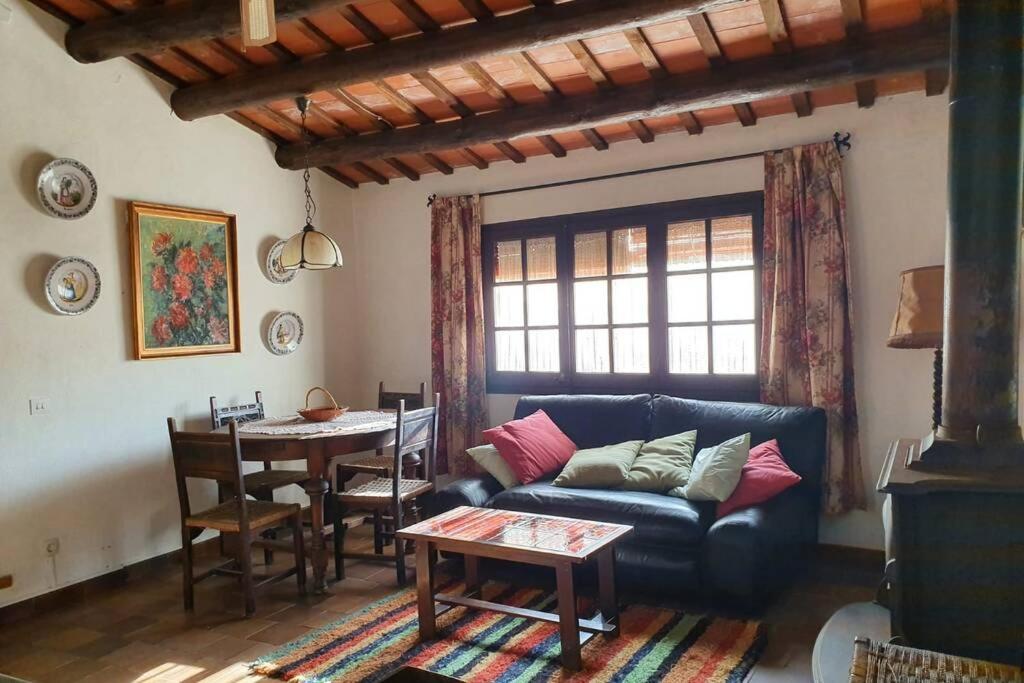 a living room with a couch and a table at Can Mas Pere in Peratallada