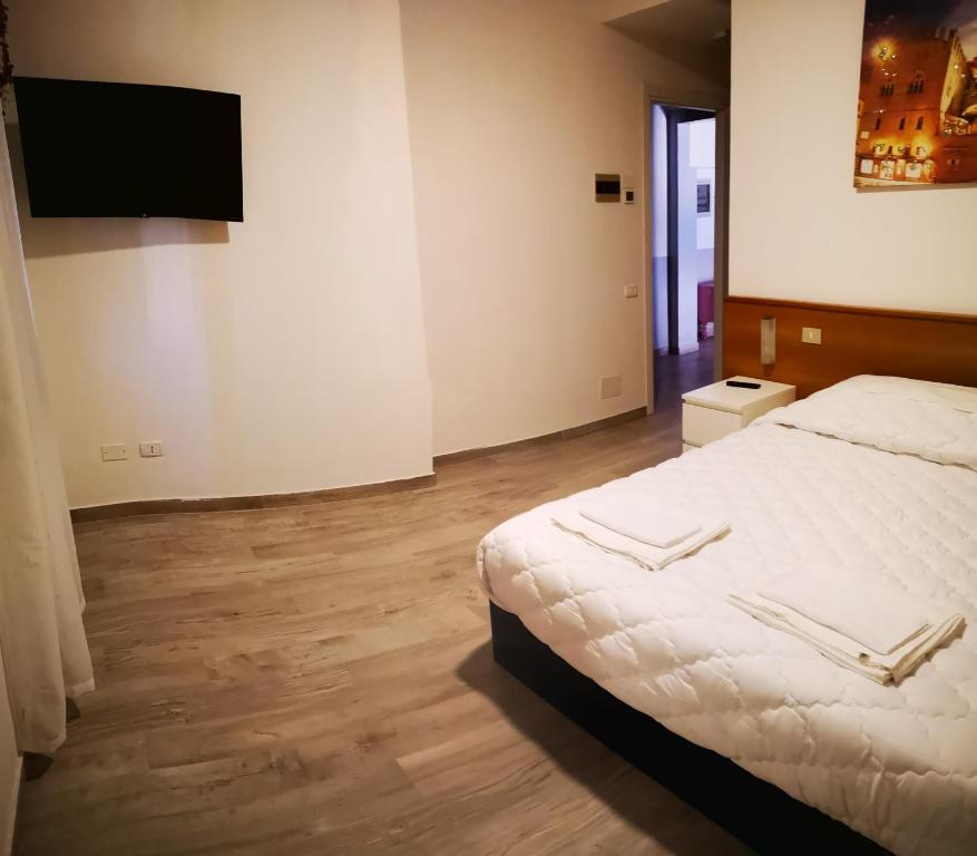 a bedroom with a bed and a flat screen tv at Il Glicine in Verona