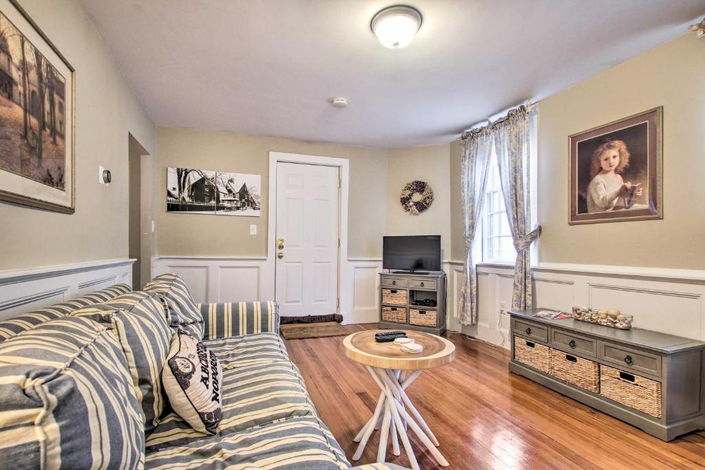 a living room with a couch and a table at Inviting Salem Apartment Near Waterfront and Museums in Salem