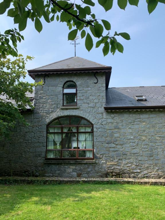 a building with a window on the side of it at Cut Limestone Apartment Riverside Lodge in Carlow