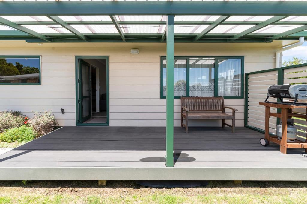 a deck with a pergola on a house at Sunrise Getaway - Rotorua Holiday Home in Ohinemutu