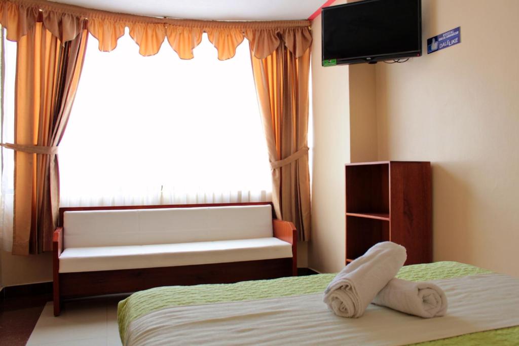 Postel nebo postele na pokoji v ubytování Hostal Dulce Amanecer