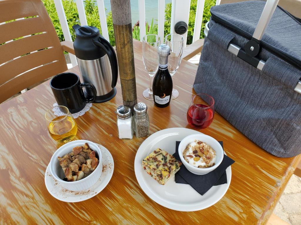 a table with two plates of food and a bowl of food at The Lakehouse Inn Geneva in Geneva-on-the-Lake