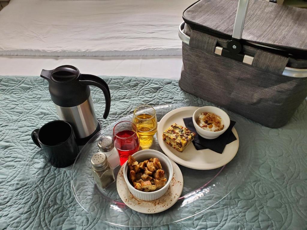 a table with a plate of food and drinks on it at The Lakehouse Inn Geneva in Geneva-on-the-Lake