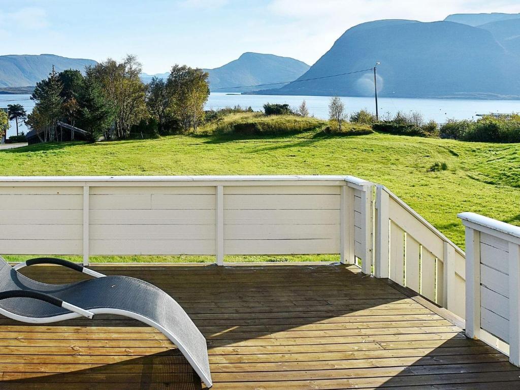 a bench on a wooden deck with a view of the water at Holiday home MIDSUND V in Midsund