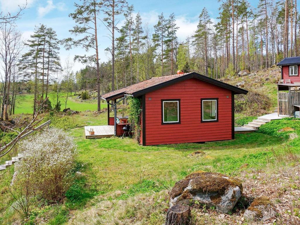 a small red house in the middle of a field at 5 person holiday home in Mellösa in Mellösa