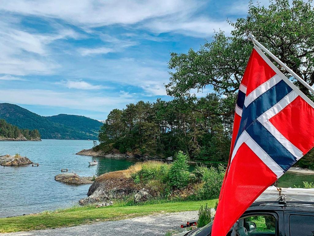 a flag is hanging on the side of a car at Seaside Serenity in Hardangerfjord-By Traum in Tyrvikbygd