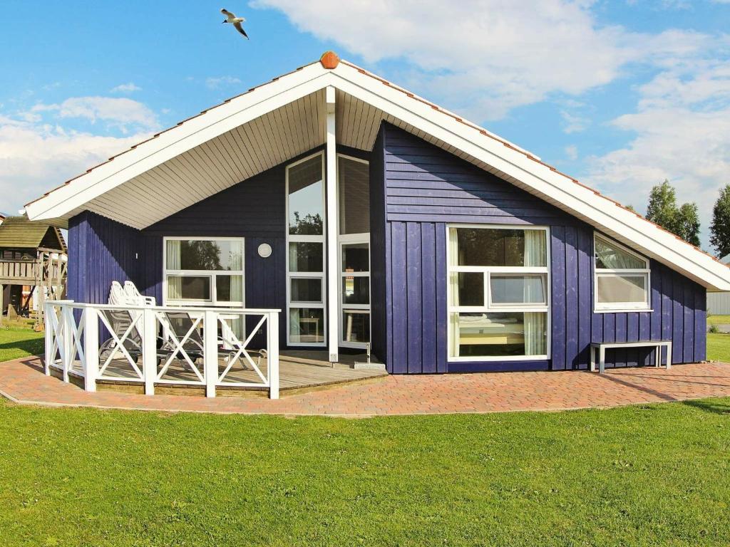 a blue house with a white roof at 12 person holiday home in Otterndorf in Otterndorf