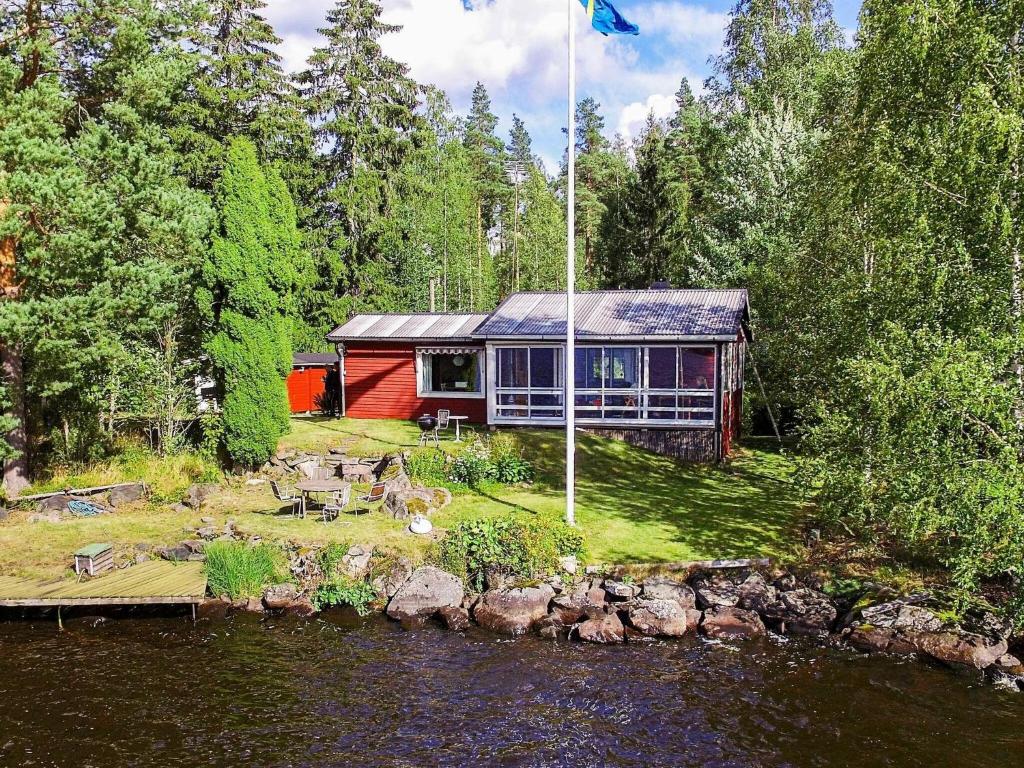 a house sitting on the side of a river at Holiday home FORSBACKA in Forsbacka