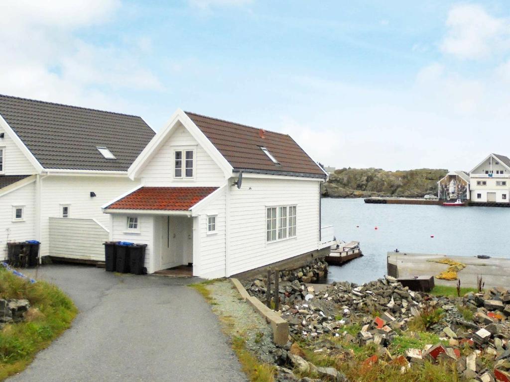 a house on the shore of a body of water at 7 person holiday home in Utsira-By Traum in Utsira