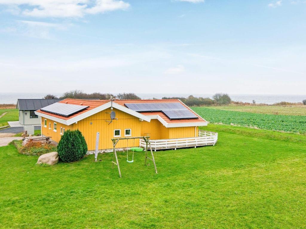een huis met zonnepanelen op een groen veld bij 8 person holiday home in Nordborg in Nordborg