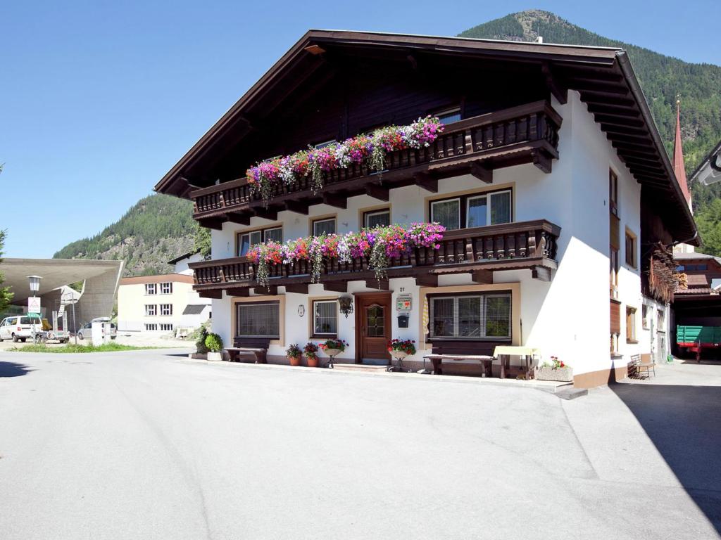 a building with flower boxes on the side of it at Apartment near the Otztal Arena ski area in Längenfeld