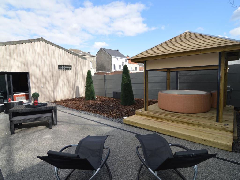 a gazebo with two chairs and a table at Home in Welkenraedt with Jacuzzi Steam Shower in Welkenraedt