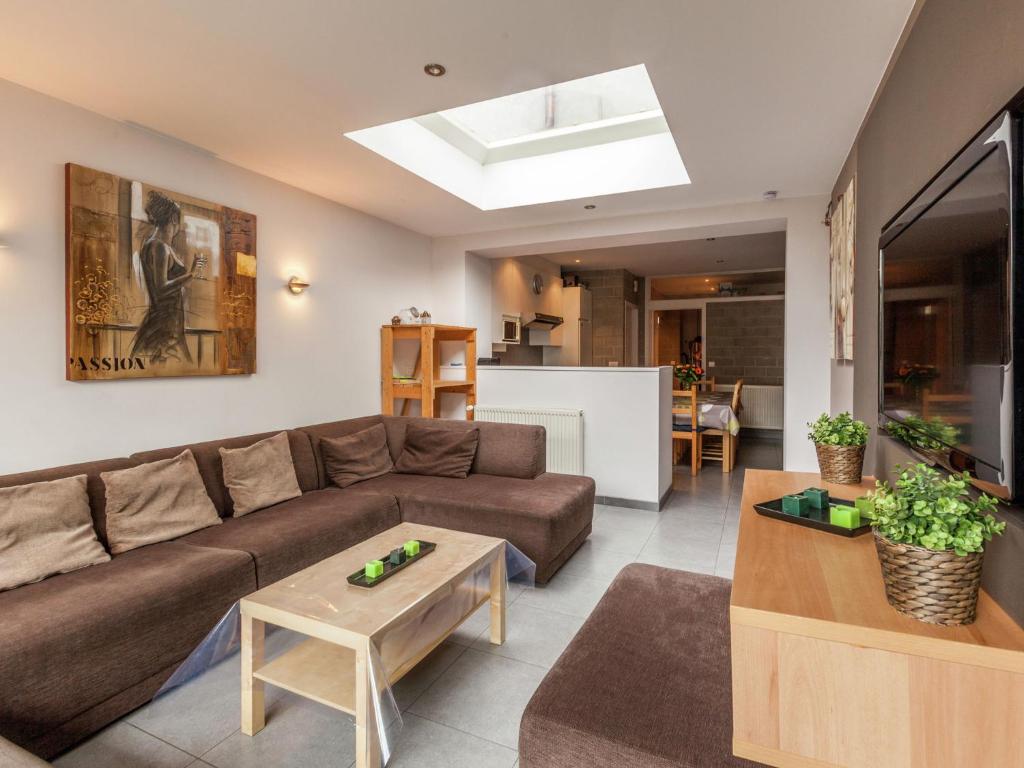 a living room with a couch and a table at Renovated city house in Kortrijk