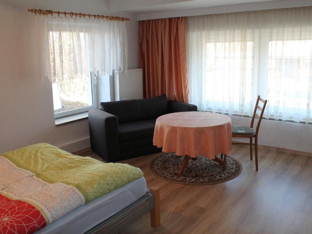 a living room with a couch and a table at Cheerful Apartment in Brusow with Terrace, Garden and Barbecue in Kröpelin