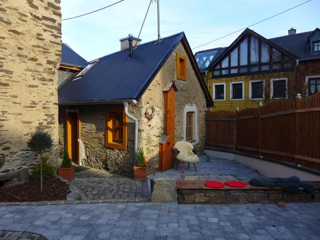 una casa con techo de metal en un patio en cosy 1800 farmhouse with sauna, en Roes