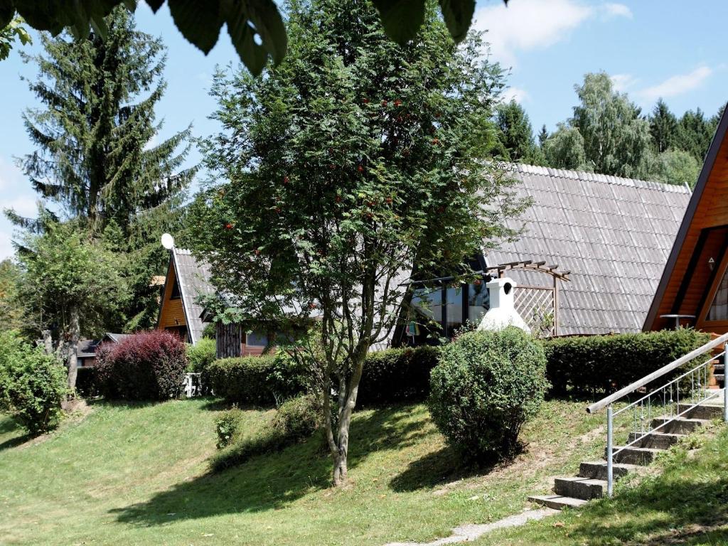 ヴァルトキルヒェンにあるDetached chalet with terrace near a swimming lakeの家の前に木のある家