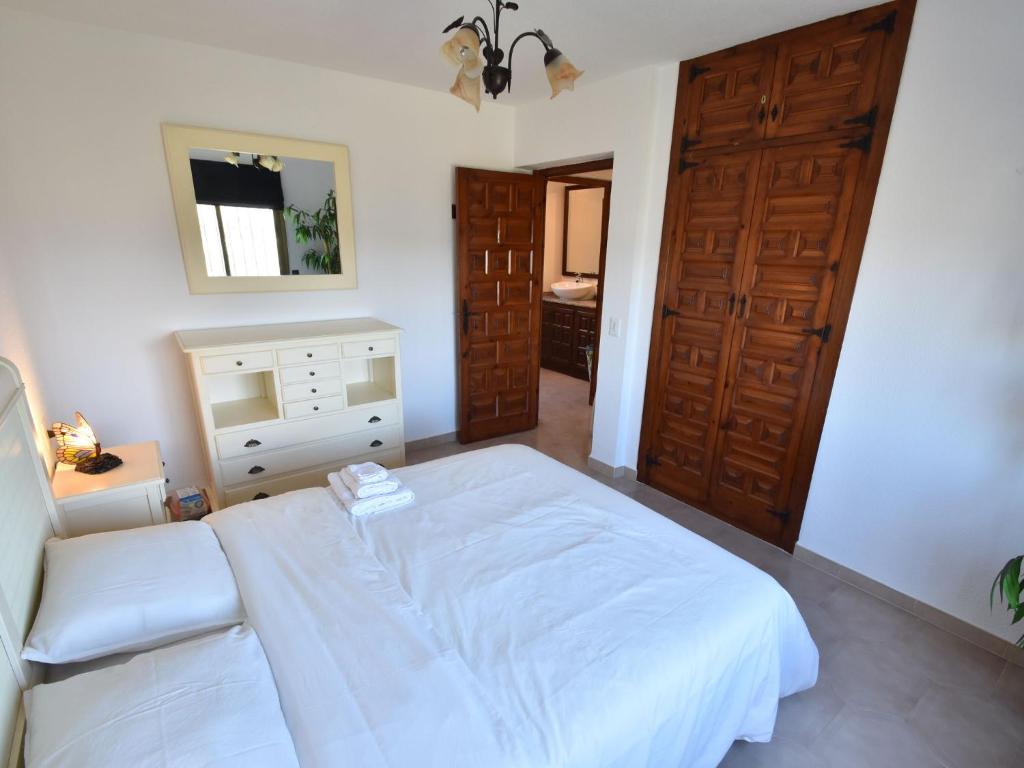 A bed or beds in a room at Villa with private pool in Benitachell