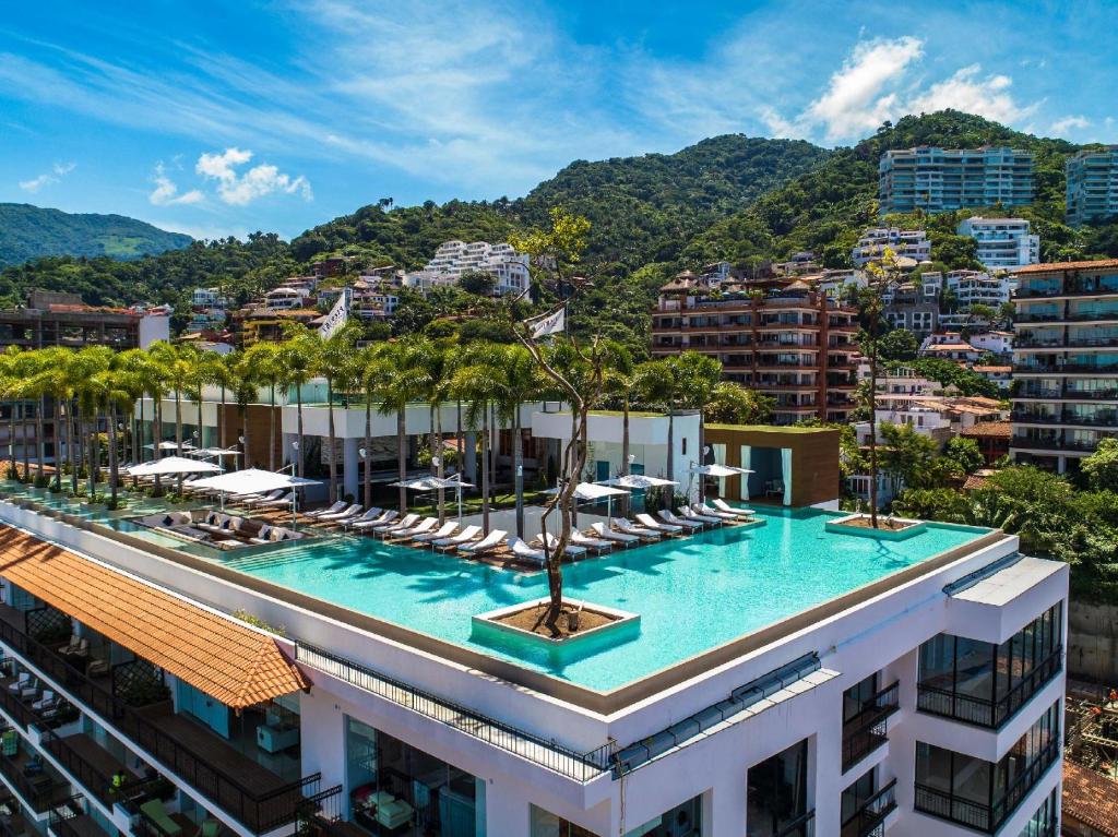 a hotel with a pool on top of a building at PIER 57 - 710 Fabulous & Luxurious 2 BR Penthouse in Puerto Vallarta