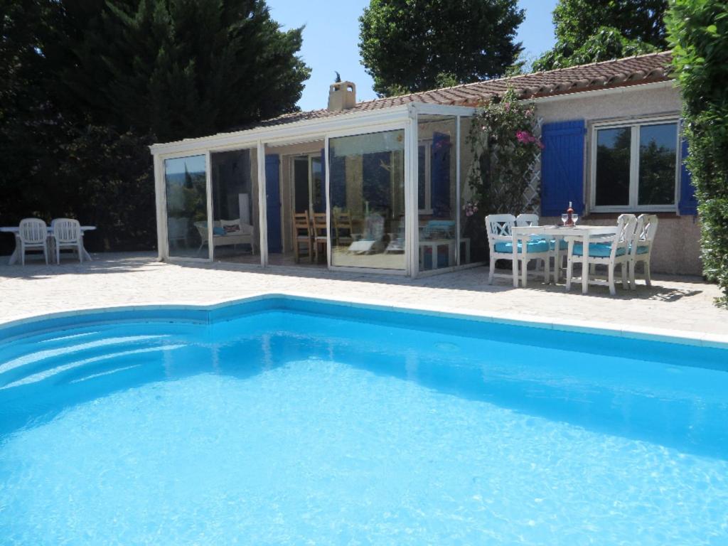 a swimming pool in front of a house at Magnificent villa with terrace in Saint-Couat-dʼAude