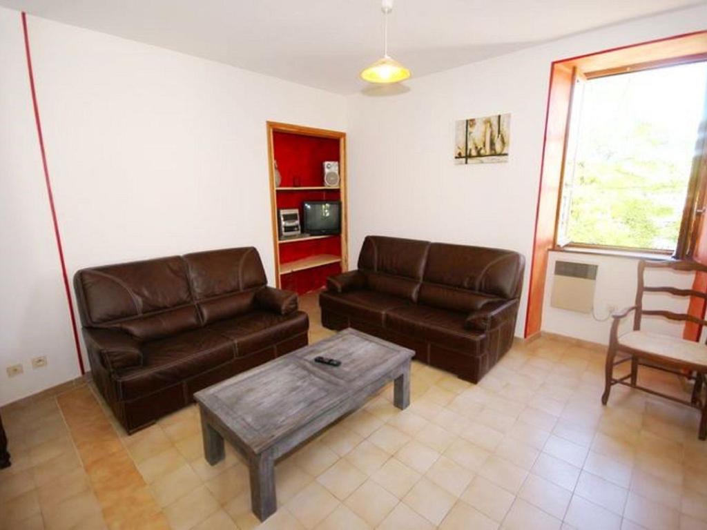 a living room with two leather couches and a coffee table at Holiday Home in a Nature Reserve in Beaulieu in Beaulieu