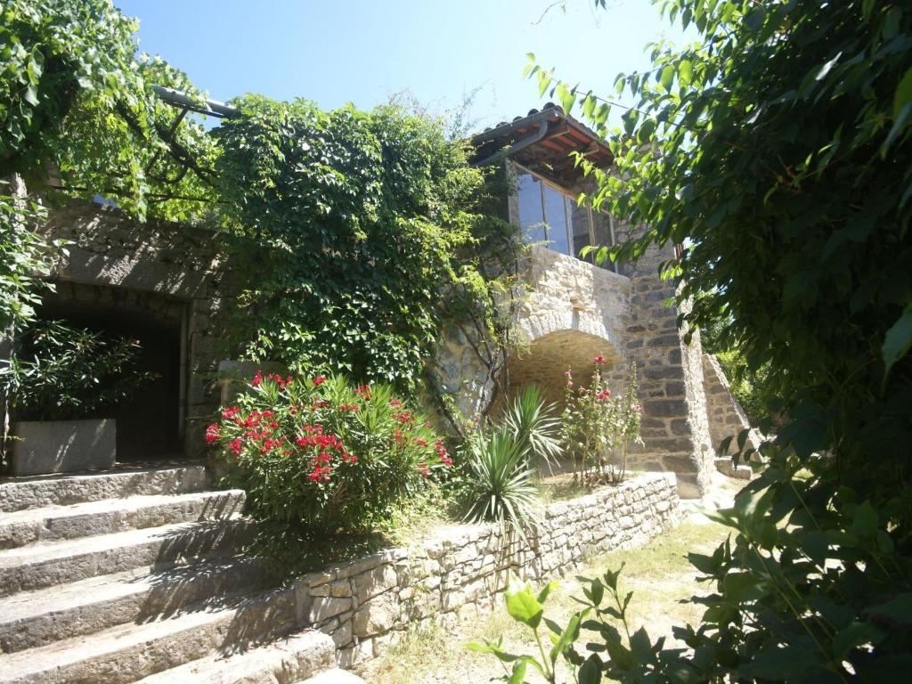 a stone house with stairs and flowers in front of it at Holiday Home in a Nature Reserve in Beaulieu in Beaulieu