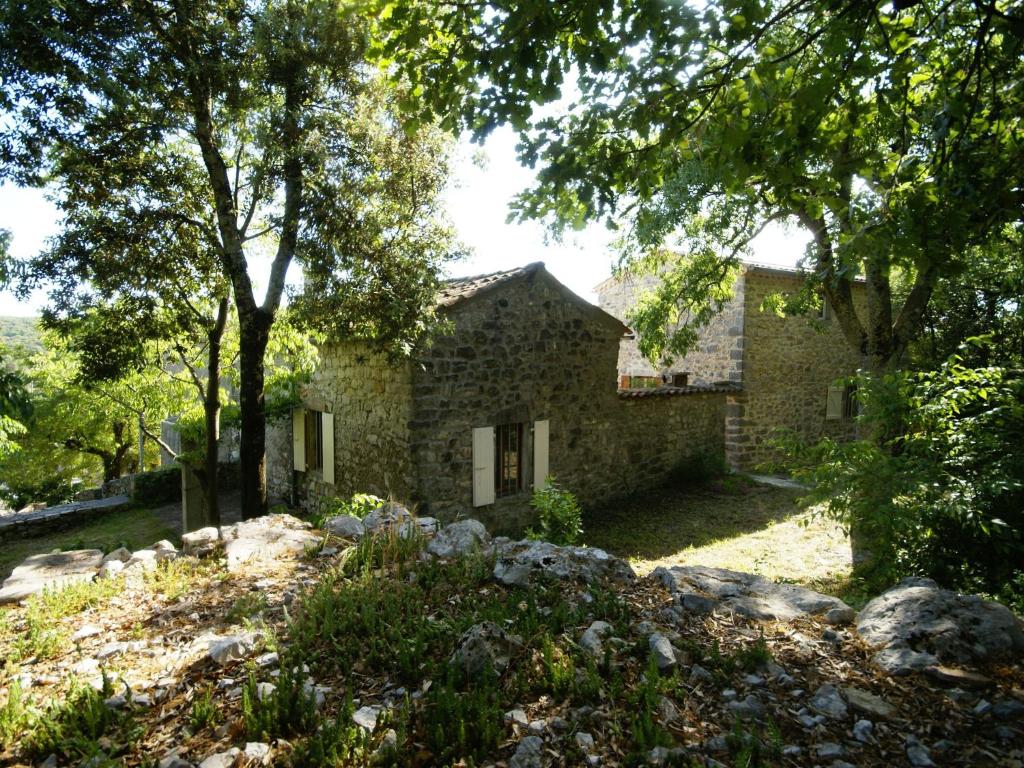 a stone house with trees in front of it at Holiday Home in a Nature Reserve in Beaulieu in Beaulieu