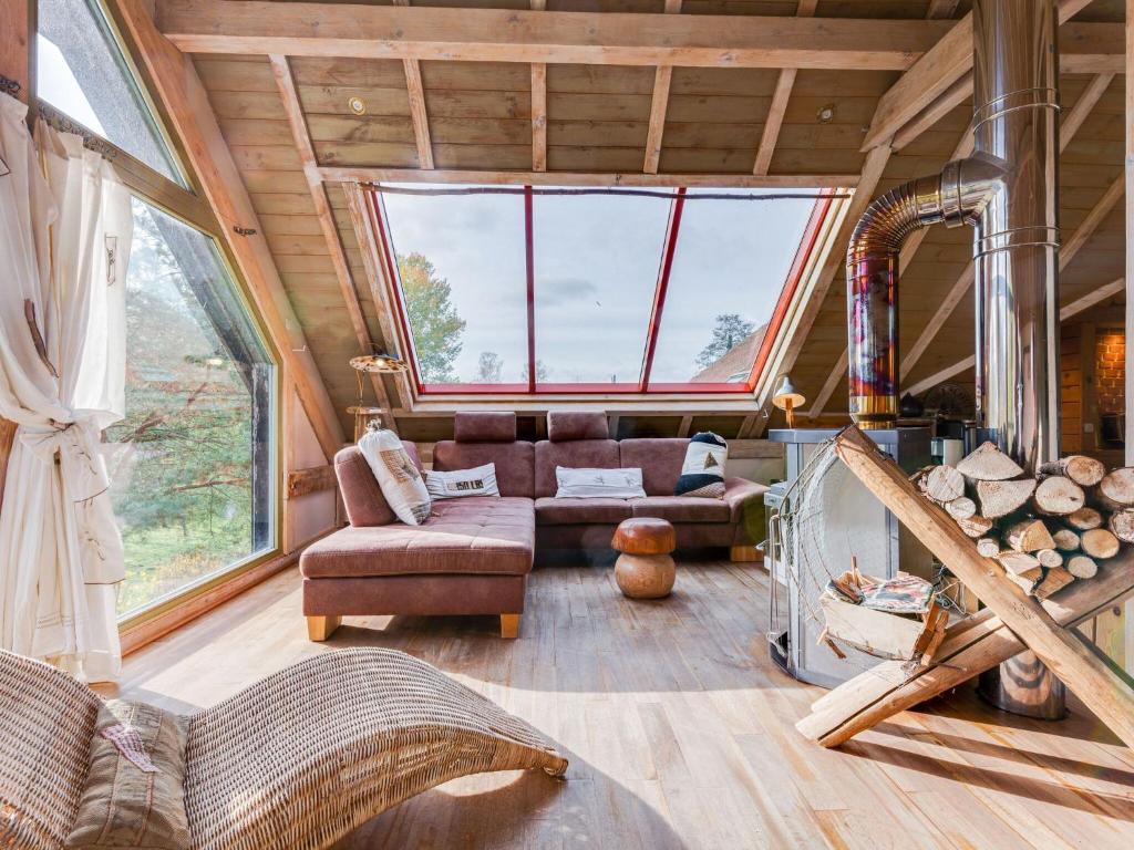 a living room in a tree house with a large window at Loft with jacuzzi and sauna in Niderviller