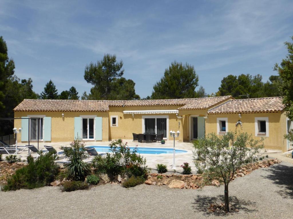 a house with a pool in front of it at Detached spacious villa with private heated pool near the Gorges du Verdon in Moissac-Bellevue