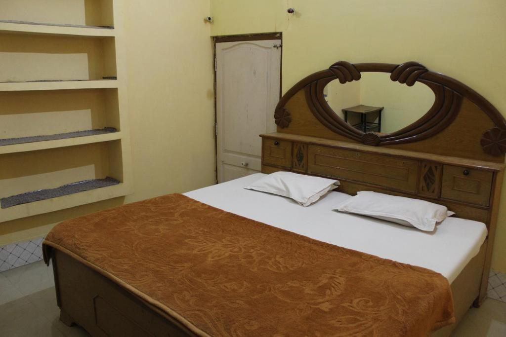 a bedroom with a bed with a mirror on it at Couple Friendly Hotel - Sunset in Orchha