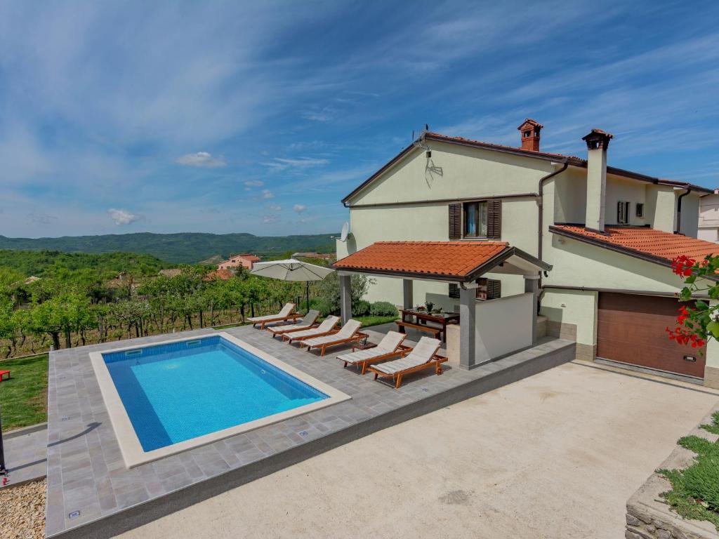 a villa with a swimming pool and a house at Apartment in Istria with Nature Views in Cerovlje