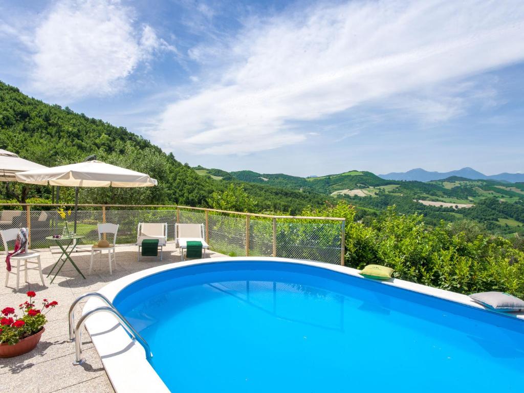 a swimming pool with a view of mountains at Belvilla by OYO Casa Volpara in Pergola