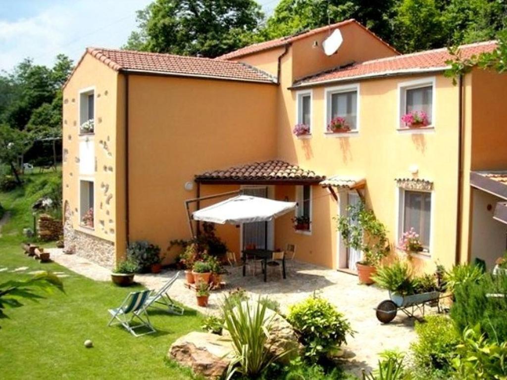 ein Haus mit einem Garten und einer Terrasse in der Unterkunft Belvilla by OYO Cozy Holiday Home with Pool in Carbuta